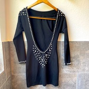 Short backless black dress with pearl detailing